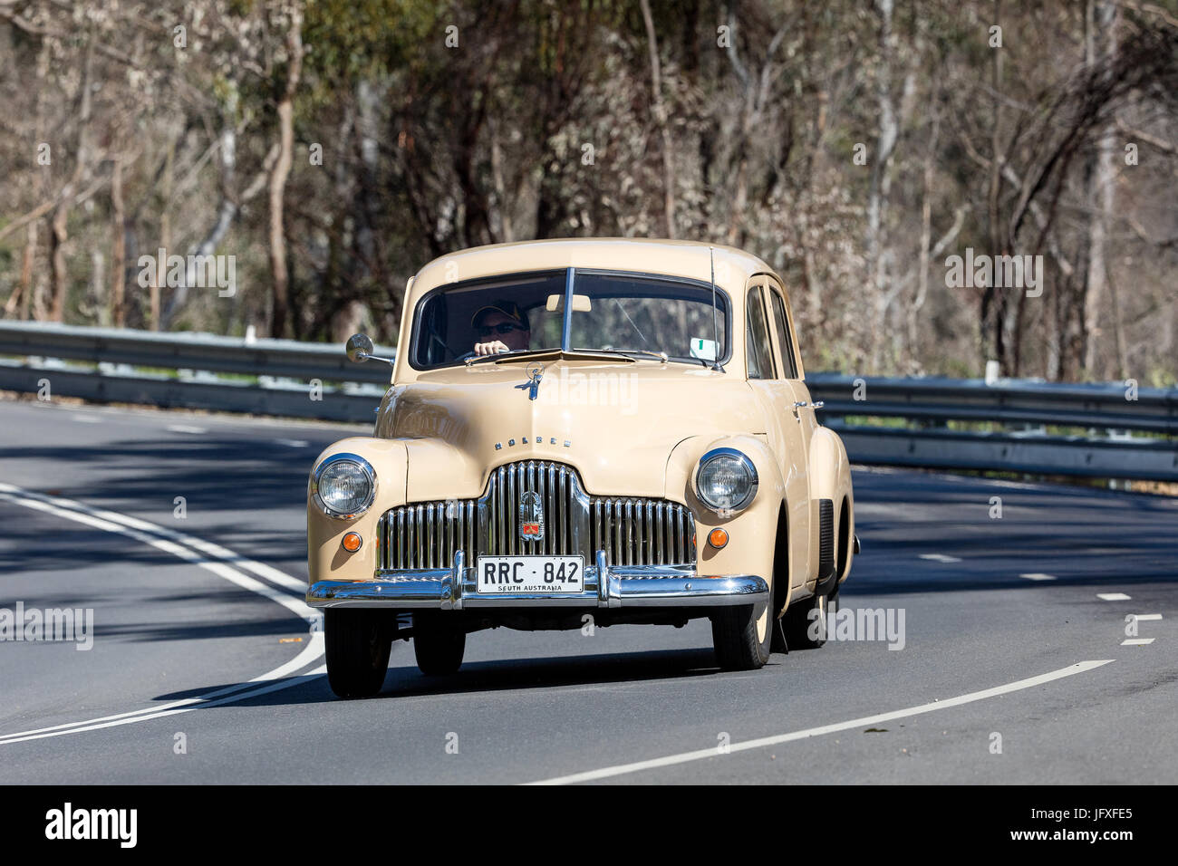 Vintage Holden driving on country roads near the town of Birdwood, South Australia. Stock Photo