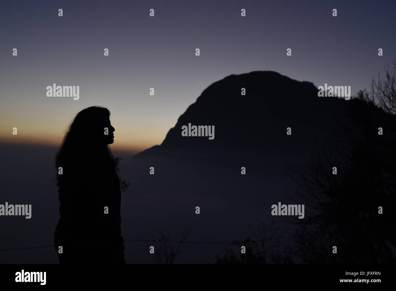 Scenic beautiful sunset view from highest point mountain with orange blue sky in the dark at Dhanaulti, Uttrakhand, India, Asia Stock Photo