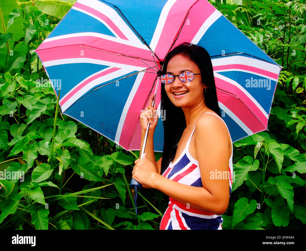 young indonesian female with union flag umbrella sunglasses and top in