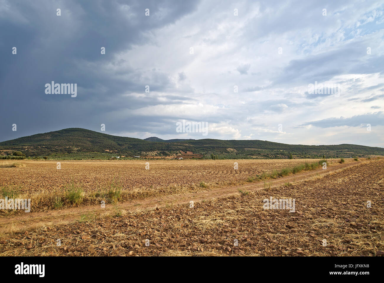 Image of storm starting in La Galinda's Mountains in Toledo, Spain. Landmark taken in Summer, showing the dryness of the terrain. Stock Photo