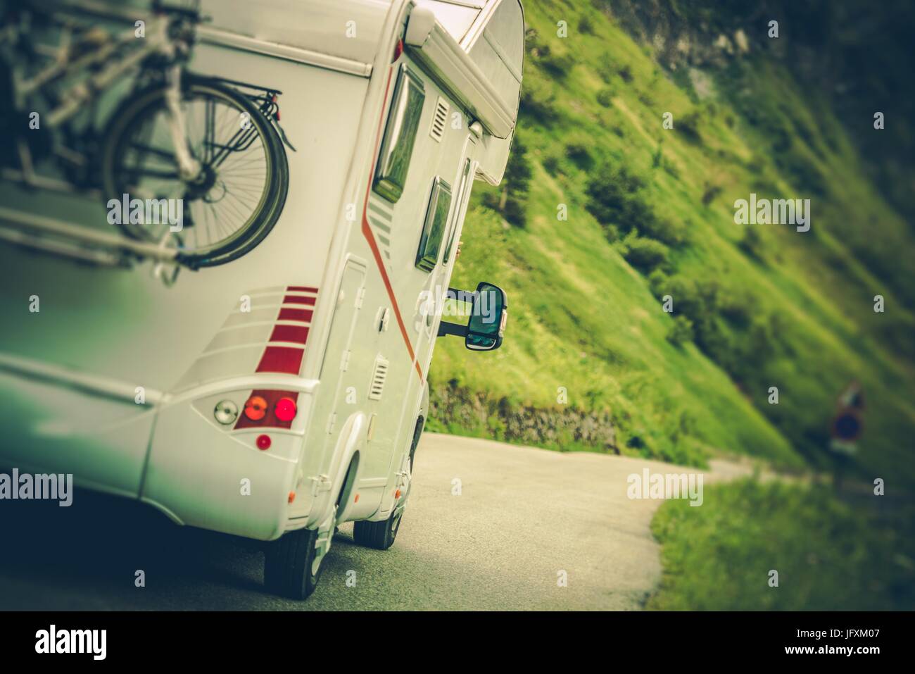 Camper Van on the Road. Class C Motorhome Coach with Bikes on the Rear ...