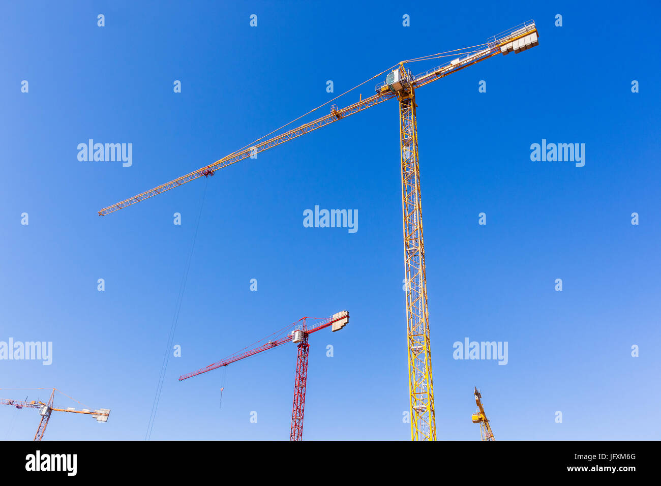 Building construction site cranes hoisting rigging machines high