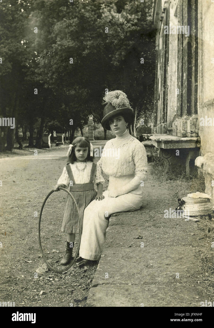 Woman dressed in white and child with hula hoop Stock Photo