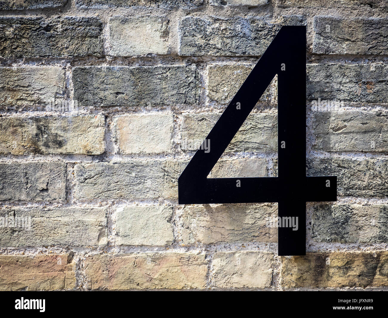 Number Four 4 on a refurbished brick building Stock Photo