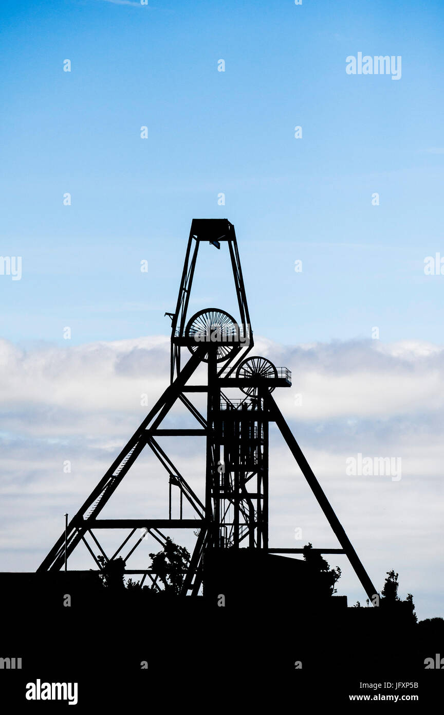 A silhouette of the headgear of New Cook's Kitchen shaft at South Crofty Mine, Pool, Cornwall. Stock Photo