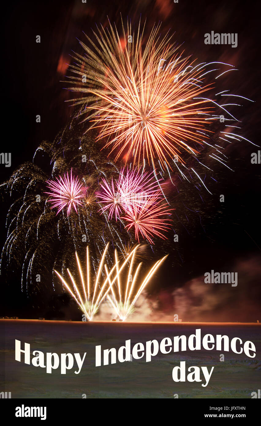Happy Independence day with fireworks over a beach Stock Photo