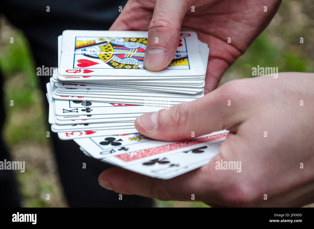 A hand holding a deck of playing cards. Stock Photo