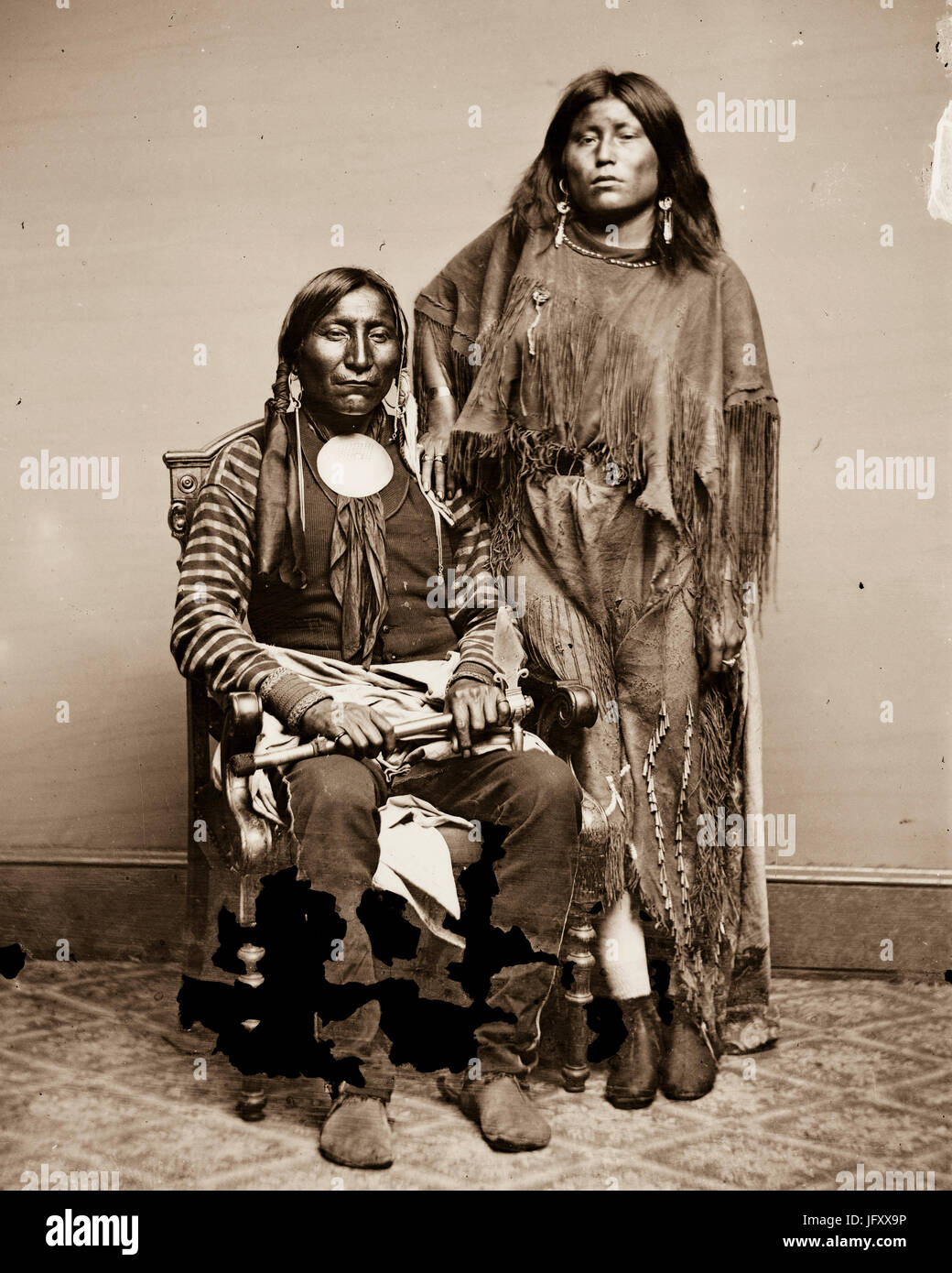 TITLE:  [Lone Wolf and his wife Etla, Kiowa Indians] CALL NUMBER:  LC-BH82- 4770 C <P&P>[P&P] REPRODUCTION NUMBER:  LC-DIG-cwpbh-01768 (digital file from original neg.) RIGHTS INFORMATION:  No known restrictions on publication. MEDIUM:  1 negative : glass, wet collodion. CREATED/PUBLISHED:  [between 1855 and 1865] Stock Photo
