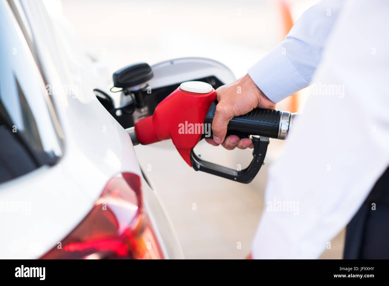 process of pouring the gasoline into the gas tank Stock Photo Alamy