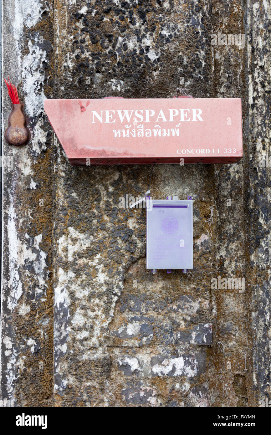 Newspaper box on old wall Stock Photo - Alamy