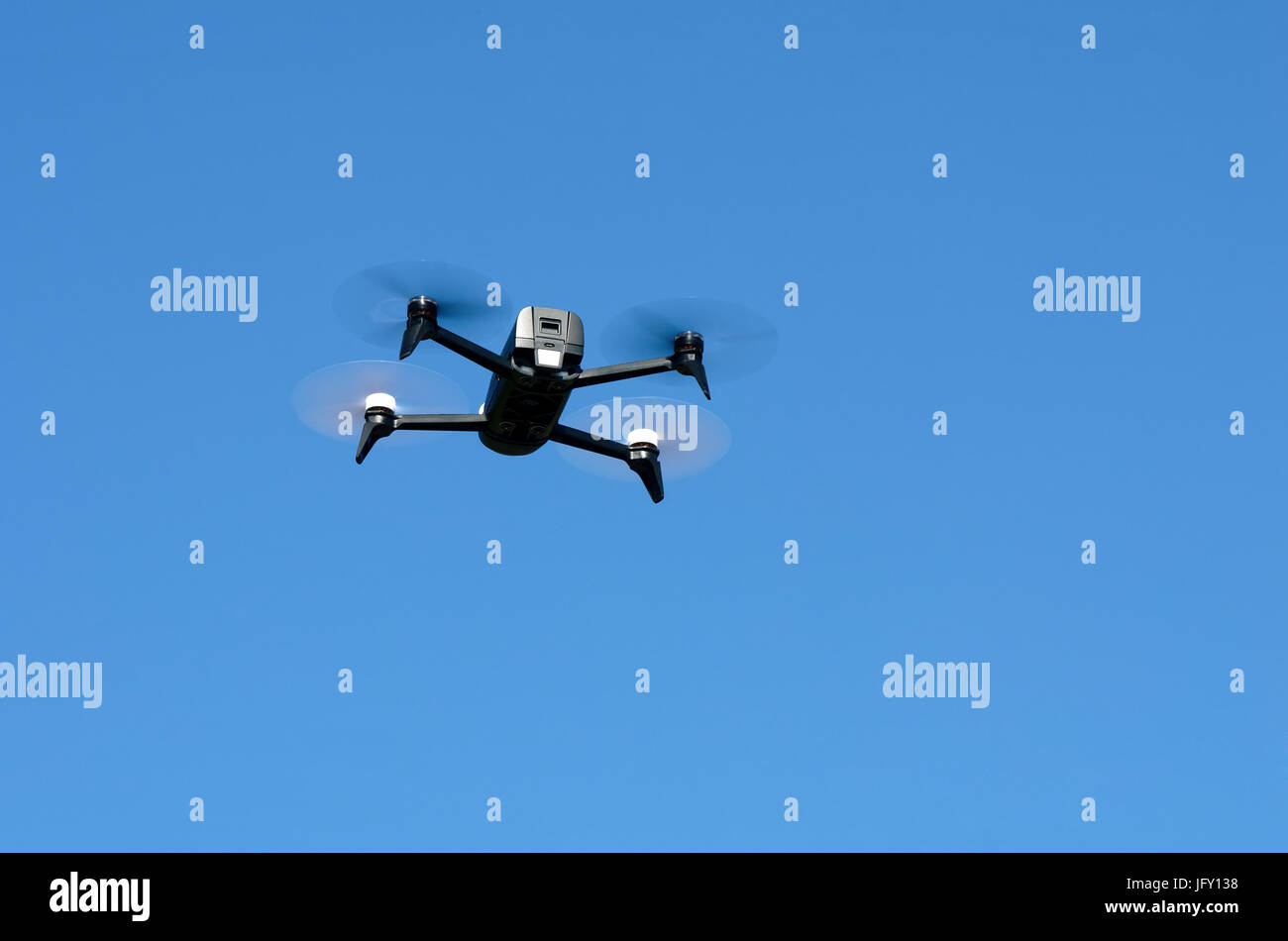Flying drone in blue sky of La Reunion Stock Photo
