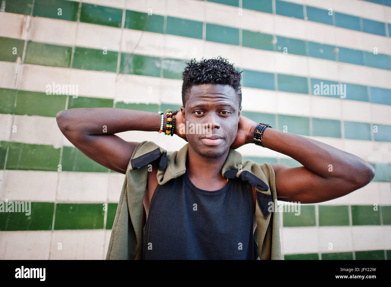 Attractive young african american guy in casual clothing standing next ...