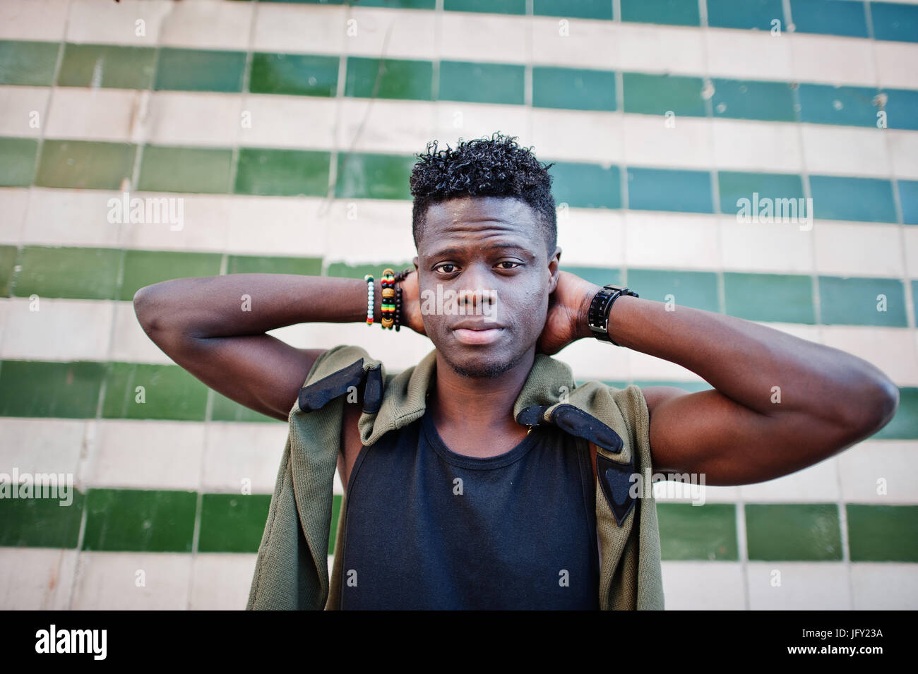 Attractive young african american guy in casual clothing standing next ...