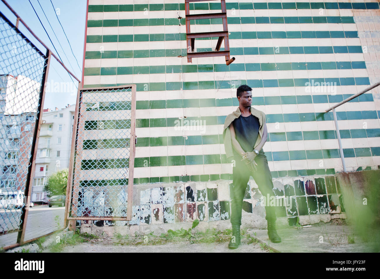 Attractive young african american guy in casual clothing standing next ...