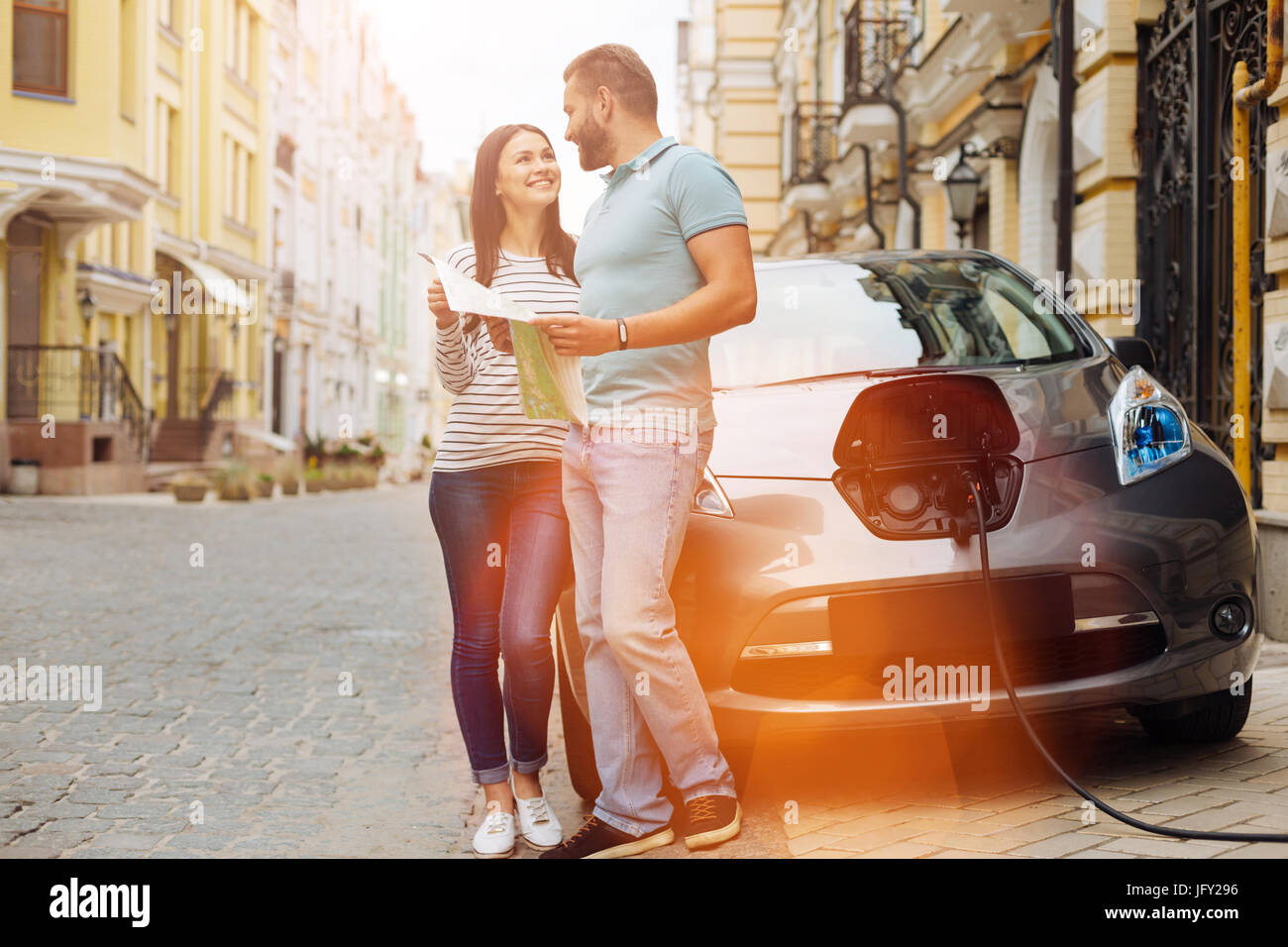 Happy couple planning their next car trip Stock Photo