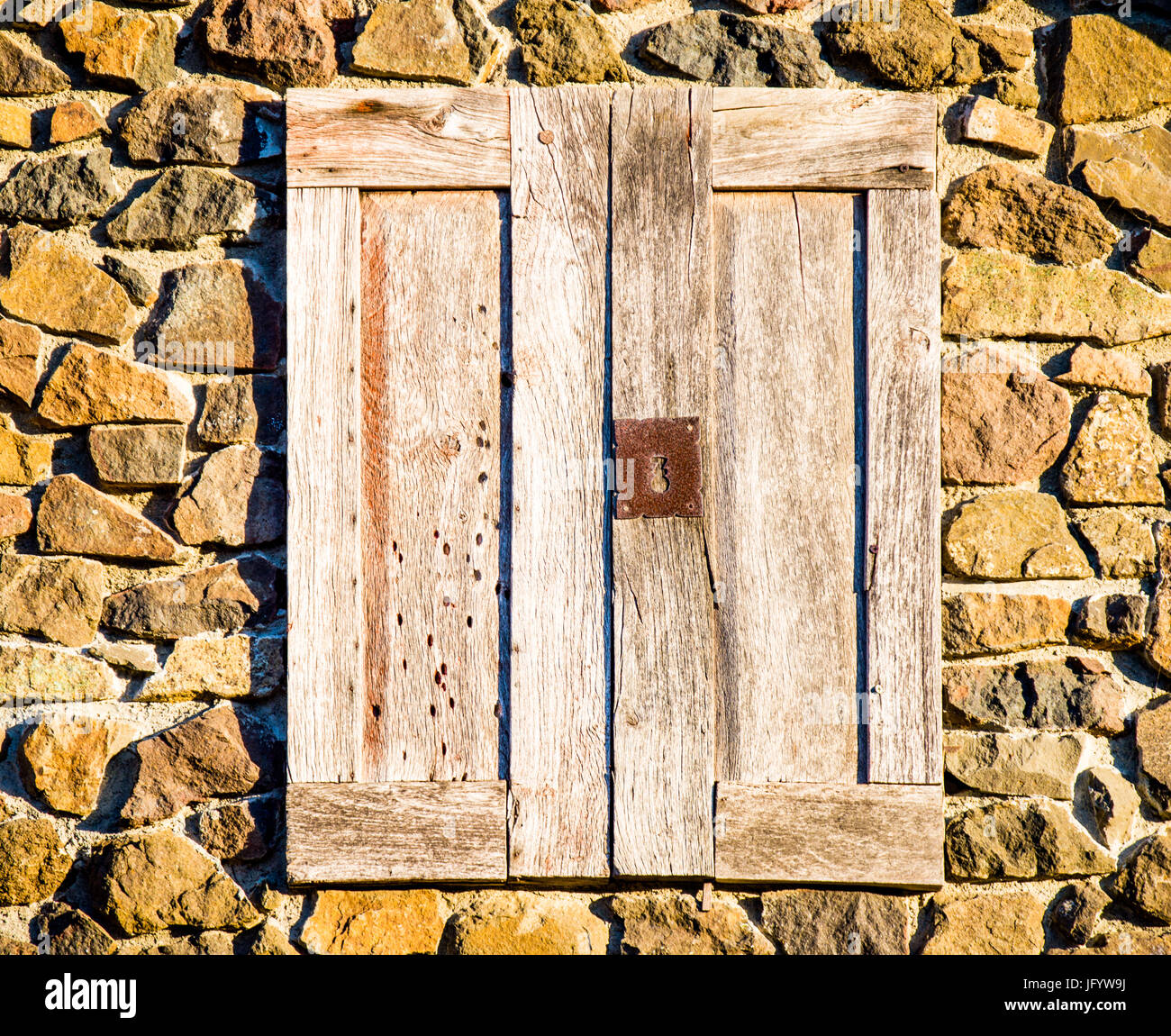 weathered door in stone wall Stock Photo - Alamy