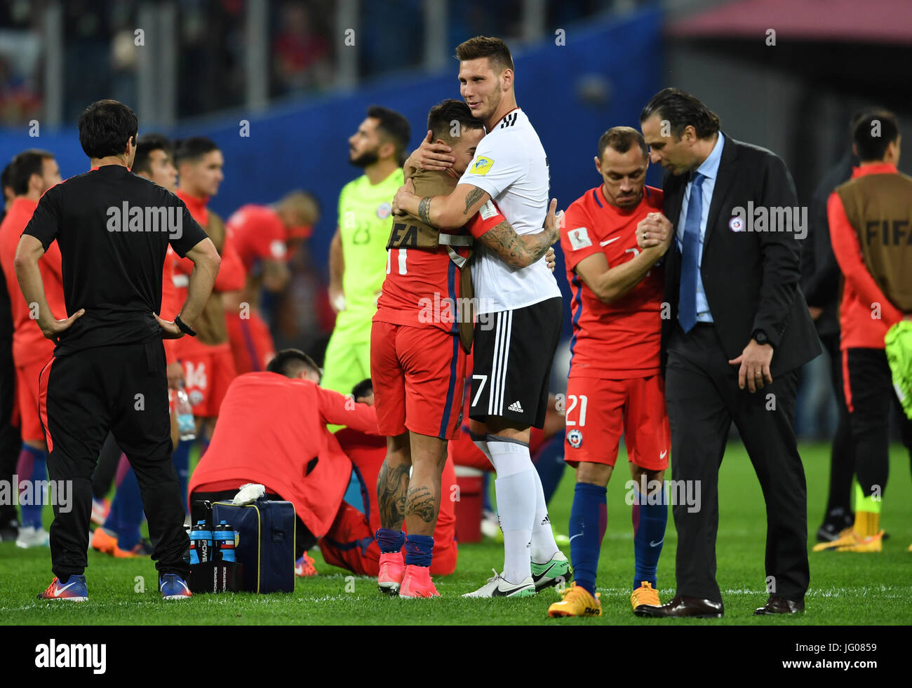 Saint Petersburg, Russia. 2nd July, 2017. Germany's Niklas Suele (M-R) hugs Chile's Eduardo Vargas after the Confederations Cup finale between Chile and Germany at the Saint Petersburg Stadium in Saint Petersburg, Russia, 2 July 2017. Photo: Marius Becker/dpa/Alamy Live News Stock Photo
