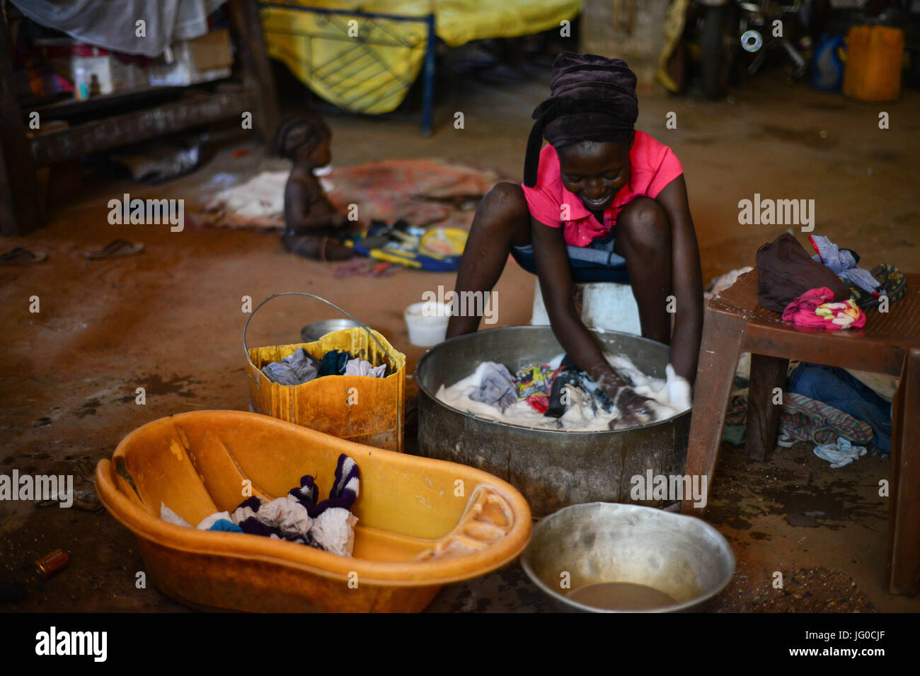 Wau, Wau, South Sudan. 3rd July, 2017. An internal displaced woman, washes her clothes with in the grounds of the St. Mary's Help of Christian Parish Cathedral in Wau South Sudan on Monday. Thousands of South Sudanese found refuge with in the grounds of the church since June 2016. Credit: Miguel Juarez Lugo/ZUMA Wire/Alamy Live News Stock Photo