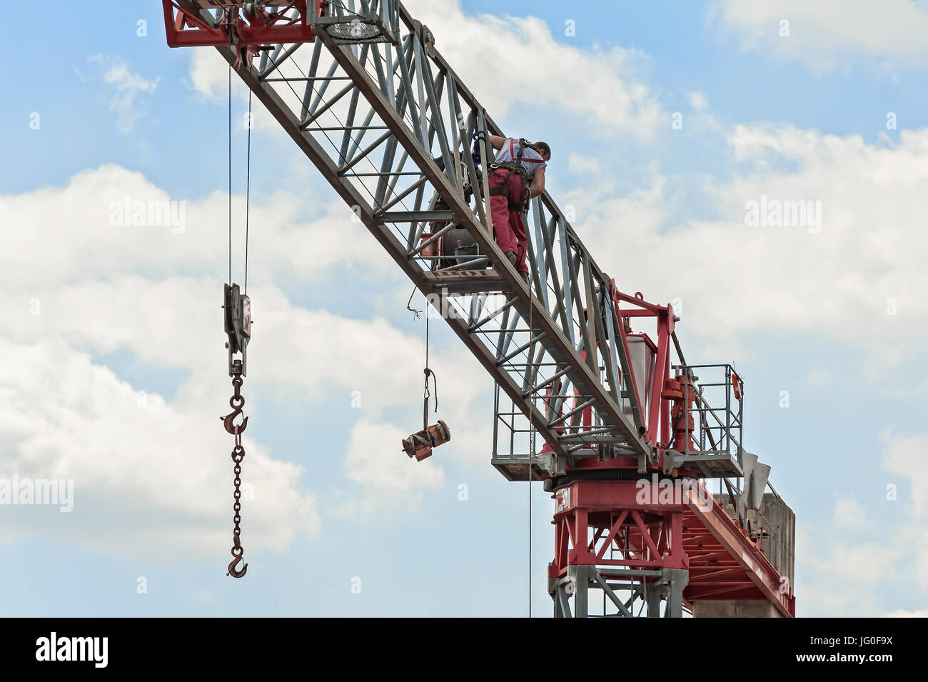 Electrician on a construction crane to repair an electric motor Stock Photo Alamy