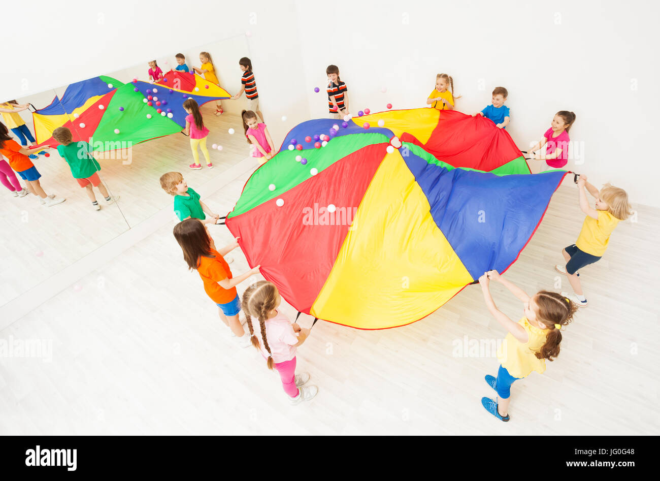 Top view picture of kids playing parachute games at school sports hall Stock Photo Alamy