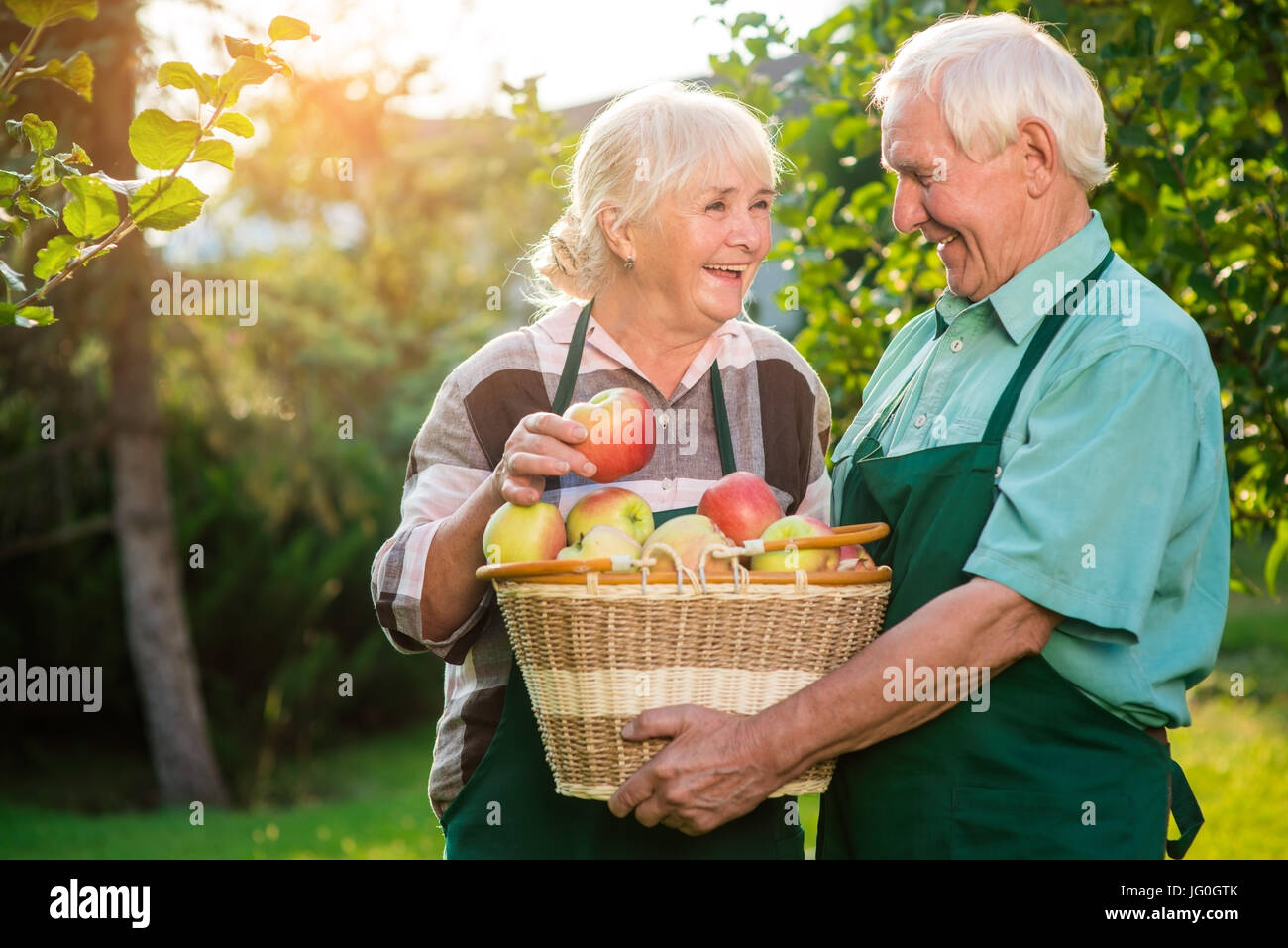Old couple and apple basket. Stock Photo