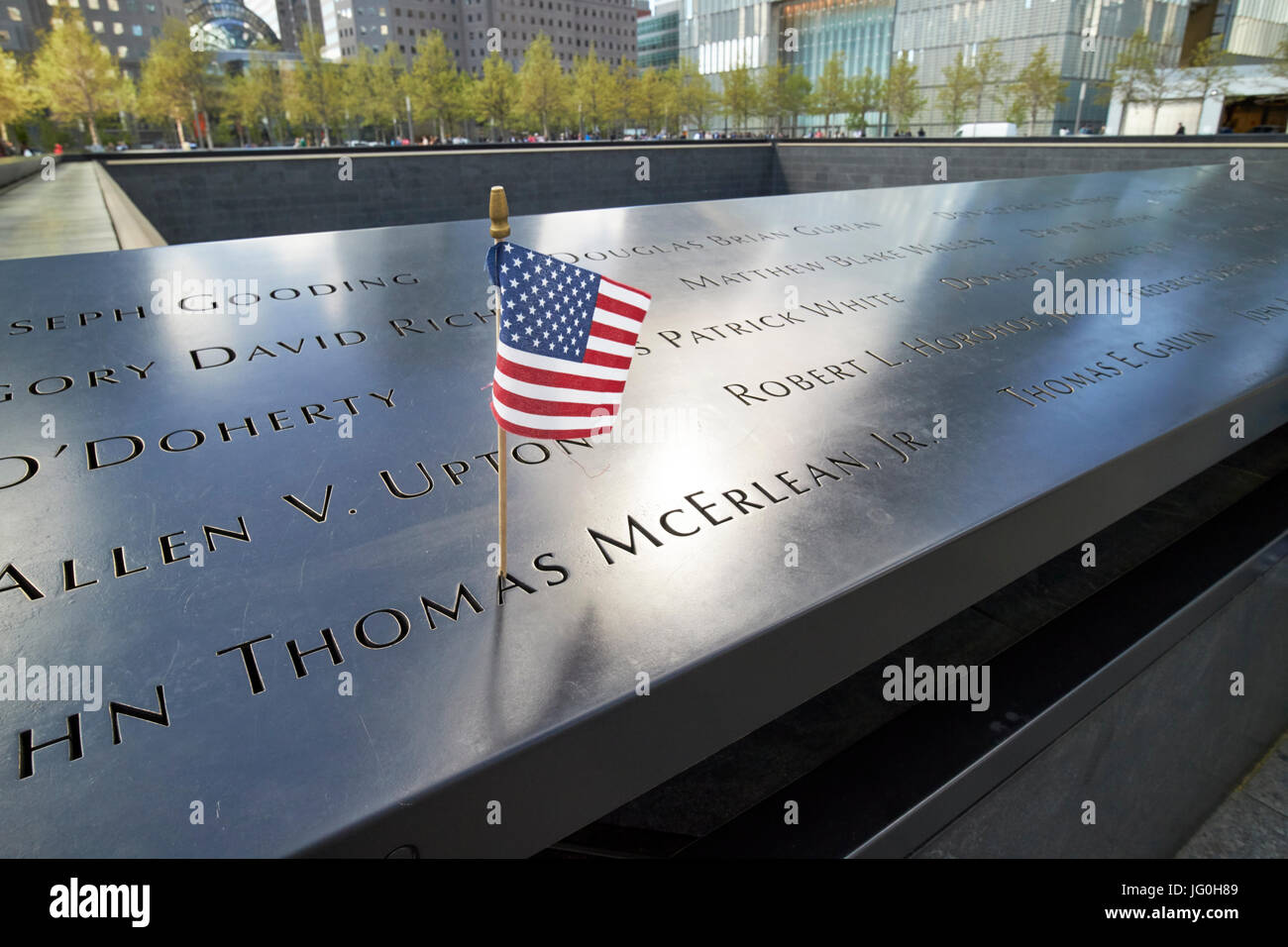 american flag on thomas mcerlean jr name on the north memorial pool former 1 world trade center footprint New York City USA Stock Photo