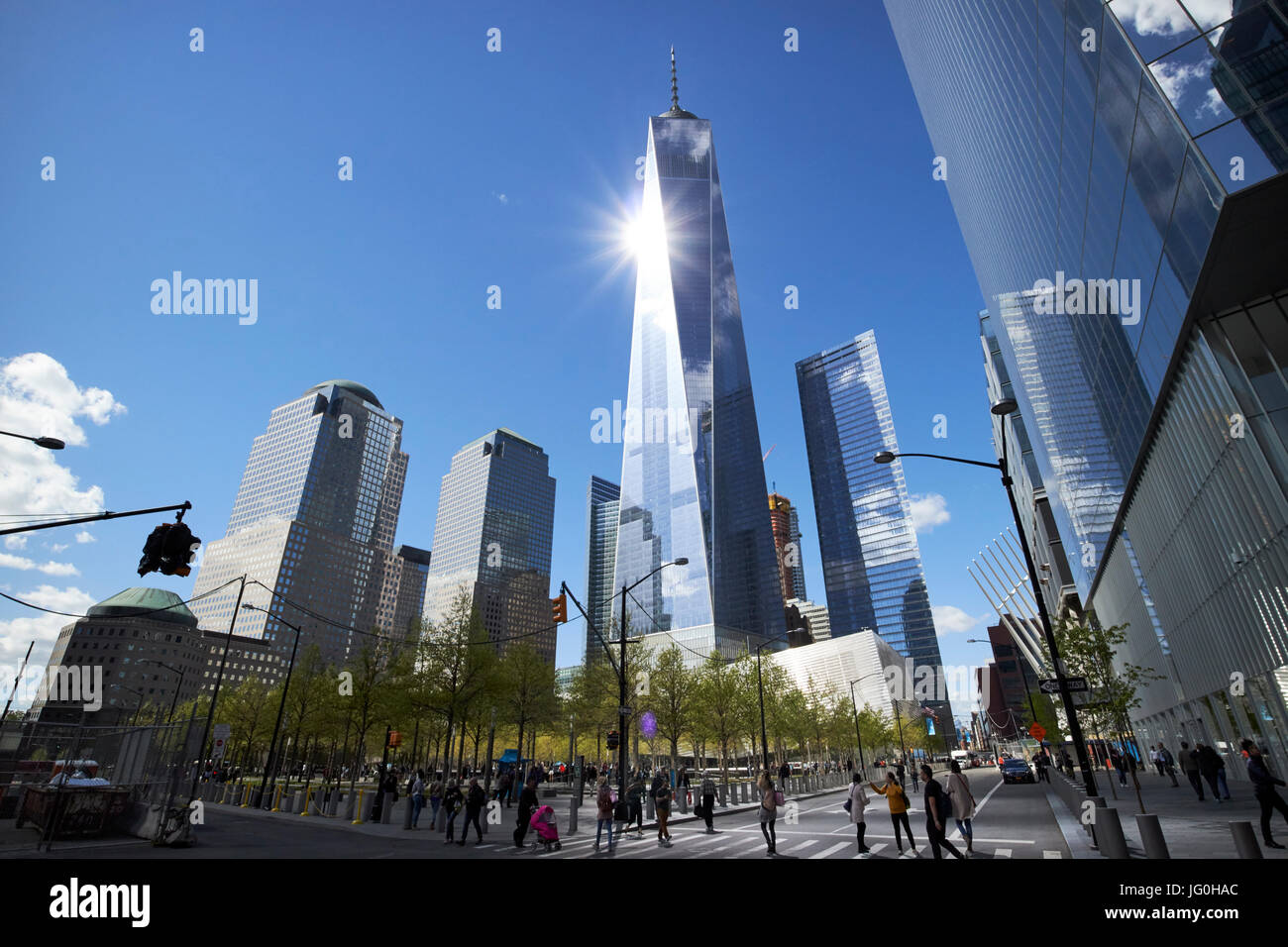 looking up at sun reflecting off one world trade center from national september 11th memorial site New York City USA Stock Photo