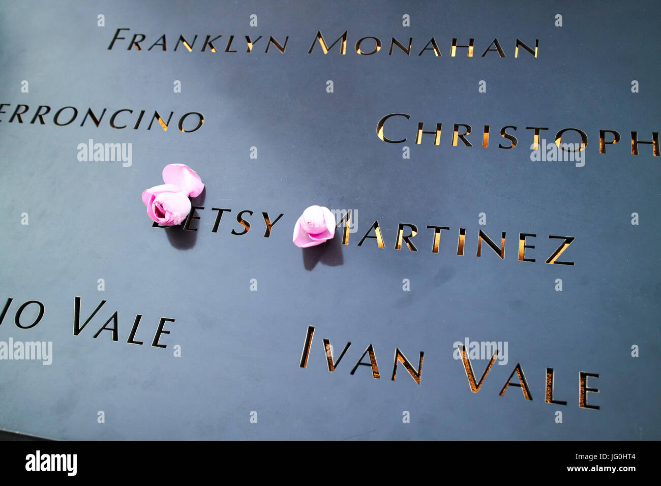 pink roses in tribute to betsy martinez name illuminated on north memorial pool former 1 world trade center footprint New York City USA Stock Photo