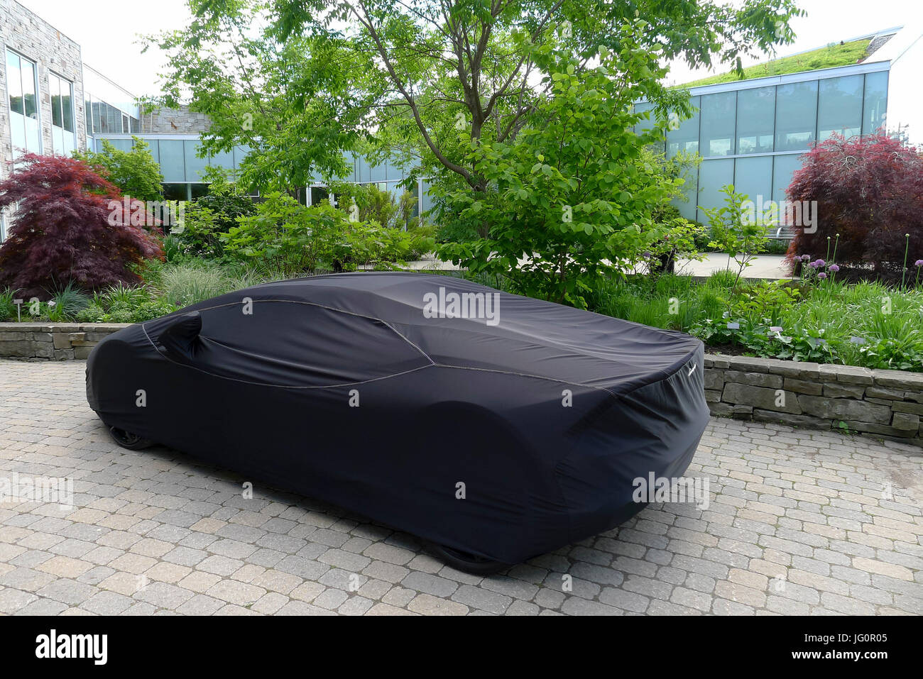 A Lamborghini huracan  soupercar covered and protected  with a custom branded car cover before an event in Toronto Canada Stock Photo