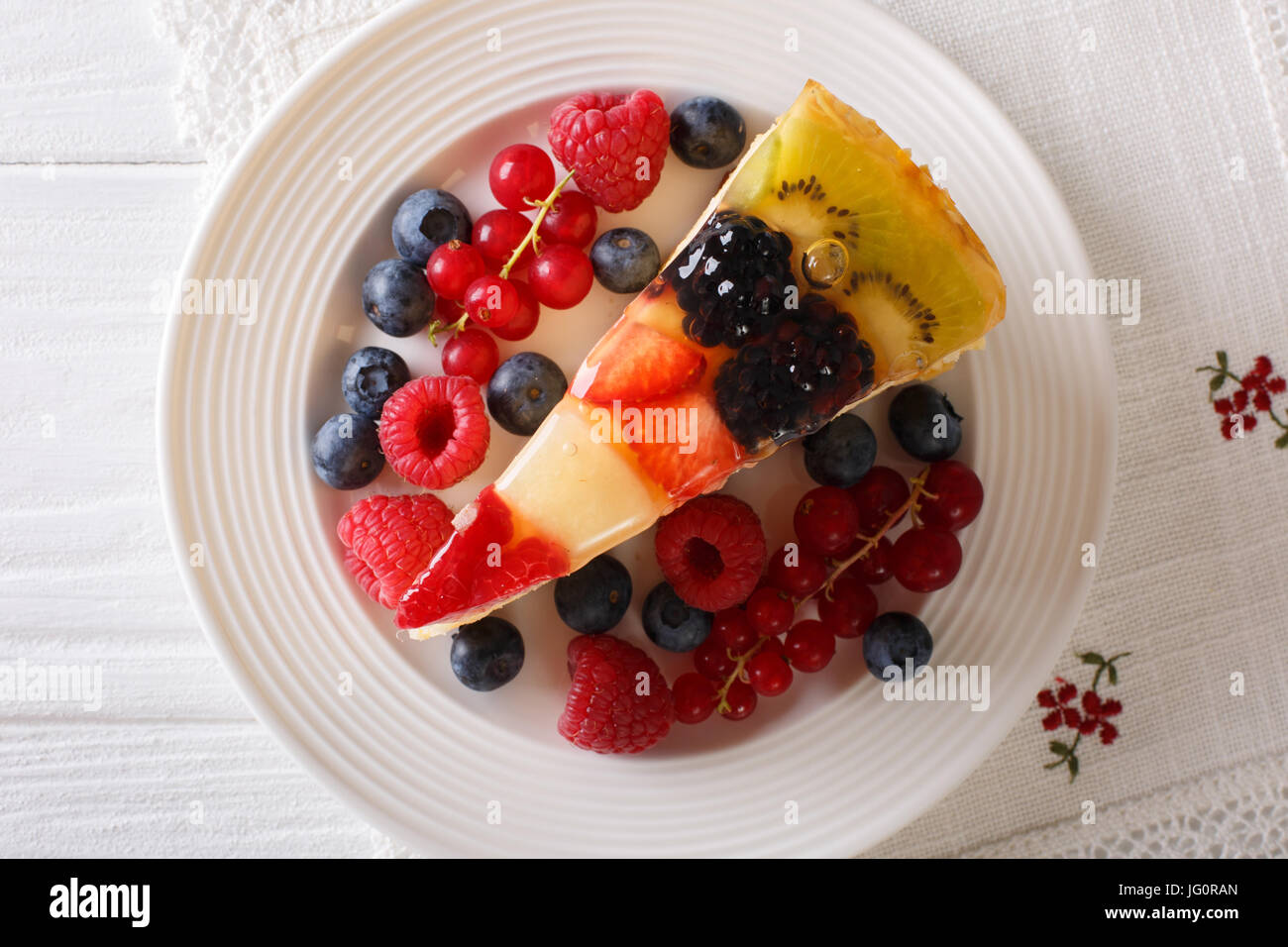 Delicious Slice of fruit berry cake close-up on a plate. Horizontal top view blue Stock Photo