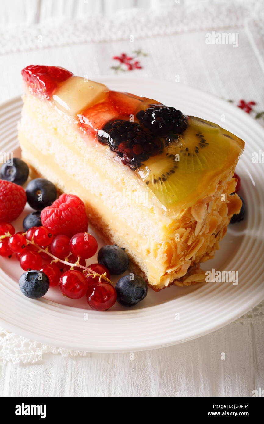 Delicious Slice of fruit berry cake close-up on a plate. Vertical Stock Photo