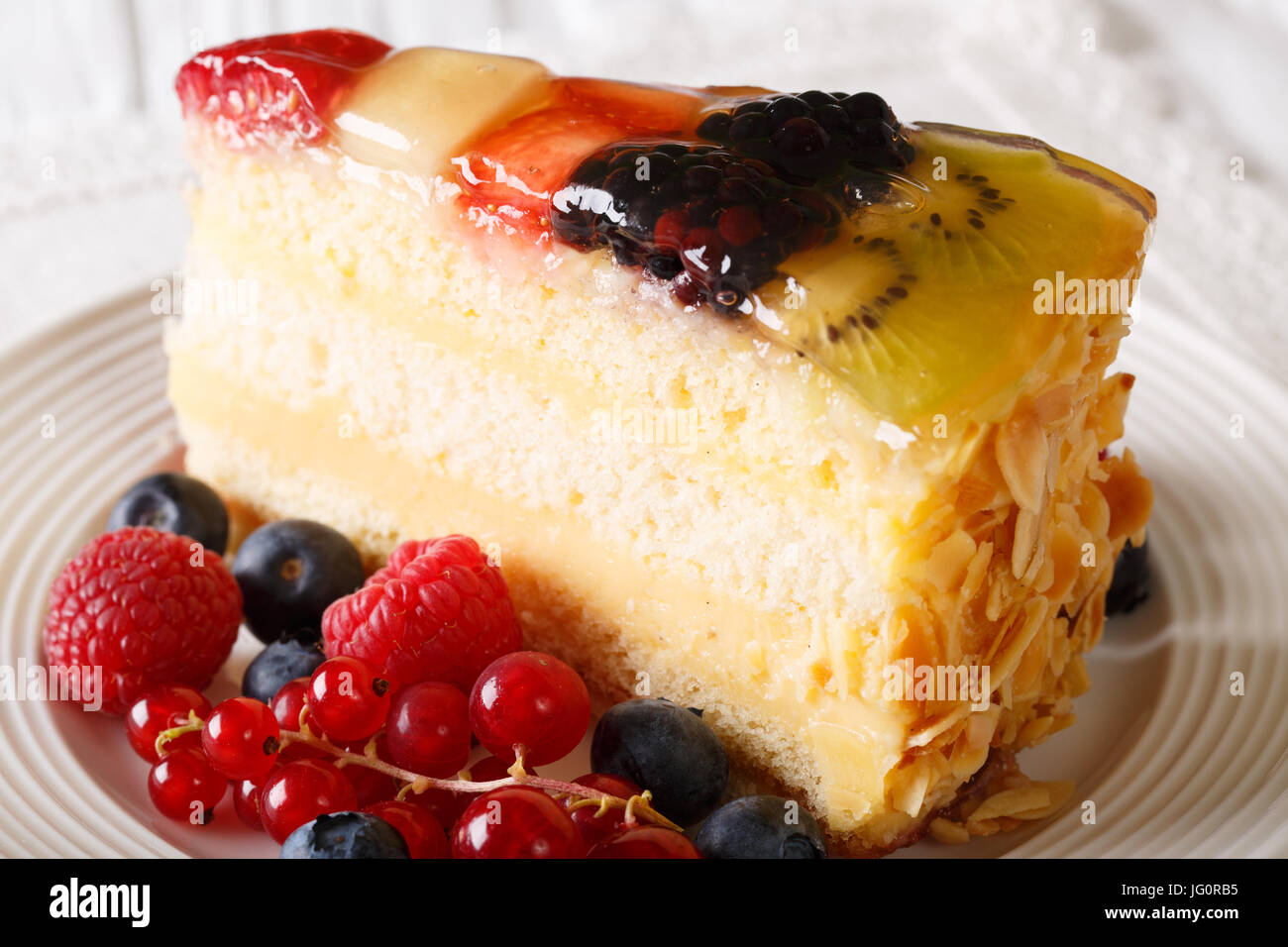 Fruit berry cake with jelly close-up on a plate. horizontal Stock Photo