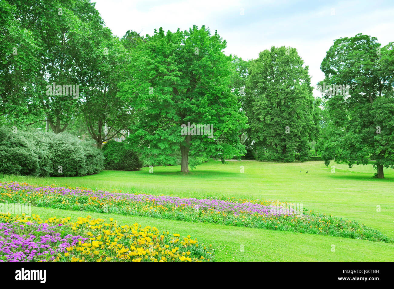 Summer park with lawn and flower garden Stock Photo - Alamy