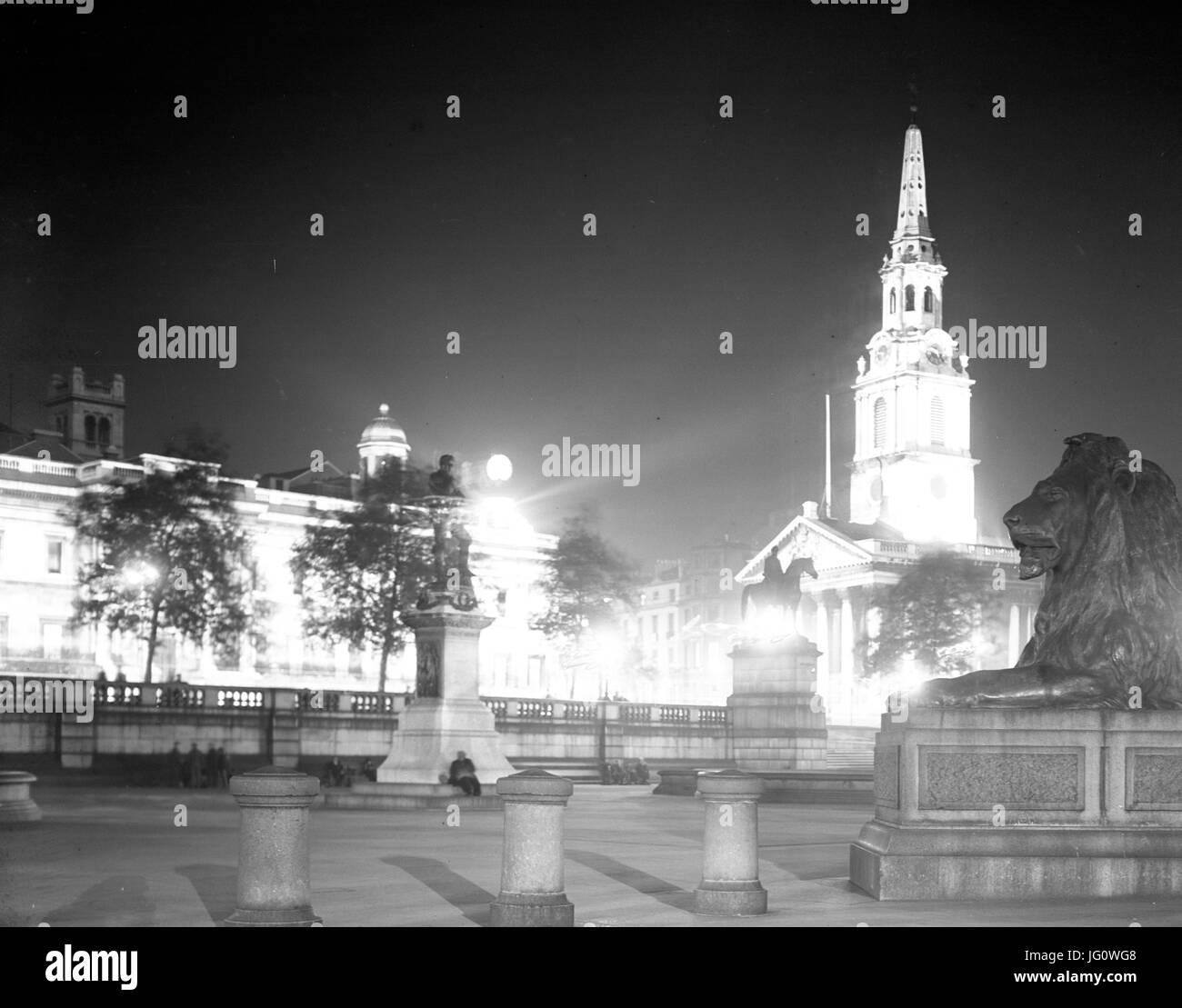 Looking across Trafalgar Square towards the National Gallery (at back on right), St Martin-in-the-Fields Church and the Coliseum (back). one of the lions on Nelson's Column is seen on right. Stock Photo