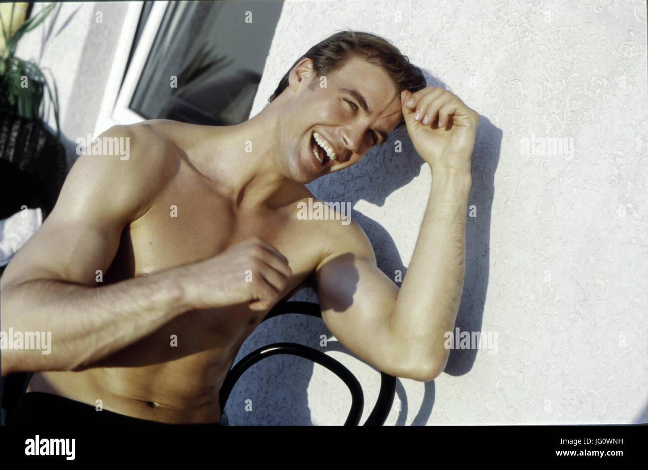 Happy man with muscles Stock Photo