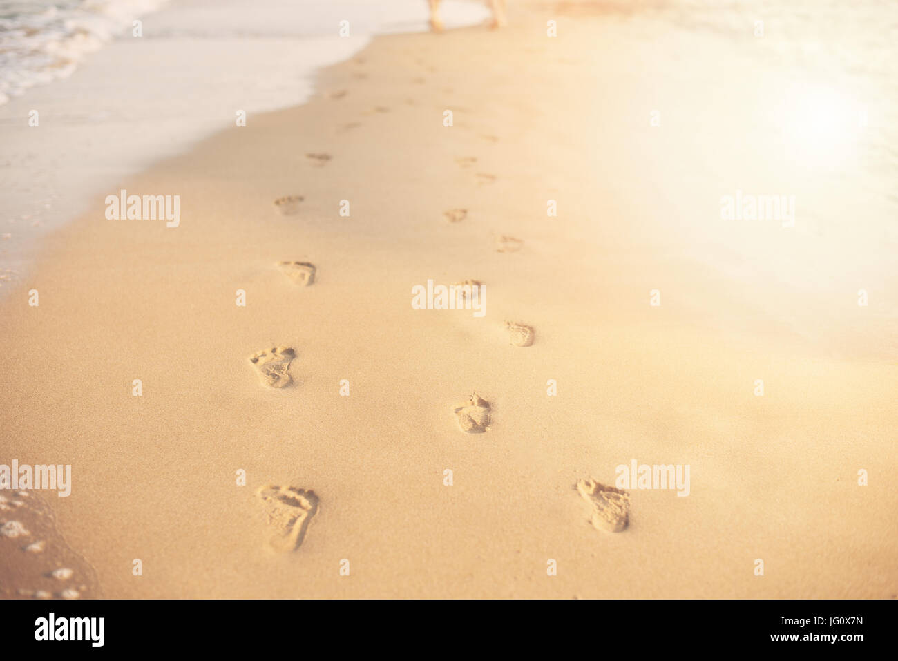 Children Footprints in the sand. Human footprints leading away from the