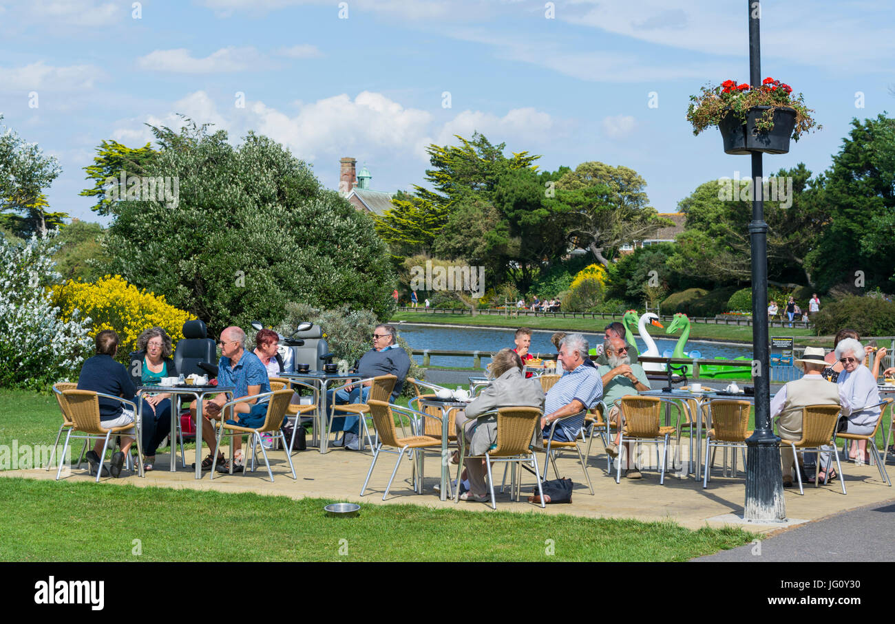 People sitting outside at a cafe in Mewsbrook Park, Littlehampton, West Sussex, England, UK. Stock Photo