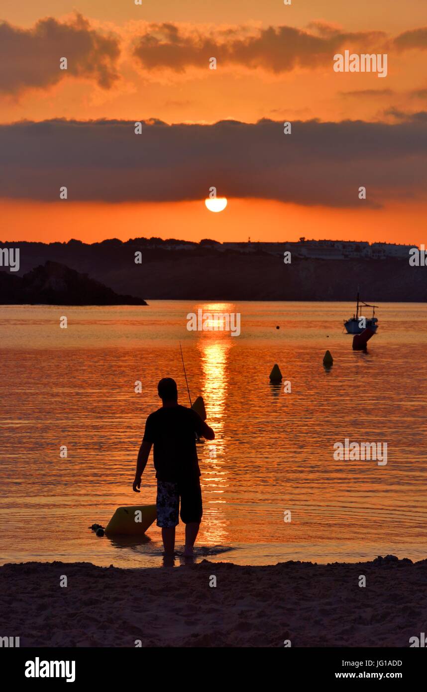 Man Fishing at Sunset Stock Photo