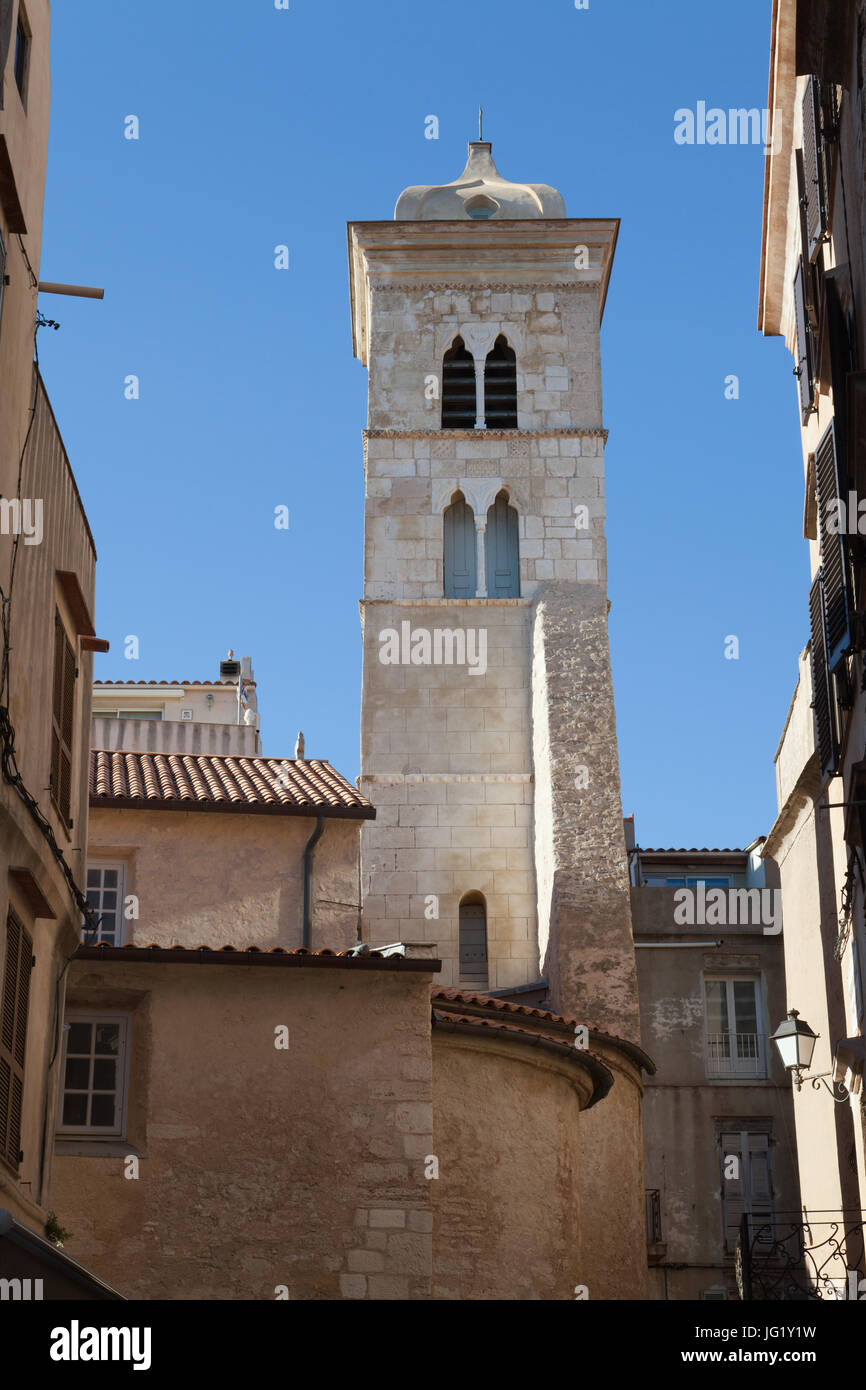 View of the bell tower and part of the Église Sainte-Marie-Majeure de Bonifacio from the narrow streets of the citadel. Corsica, France. Stock Photo
