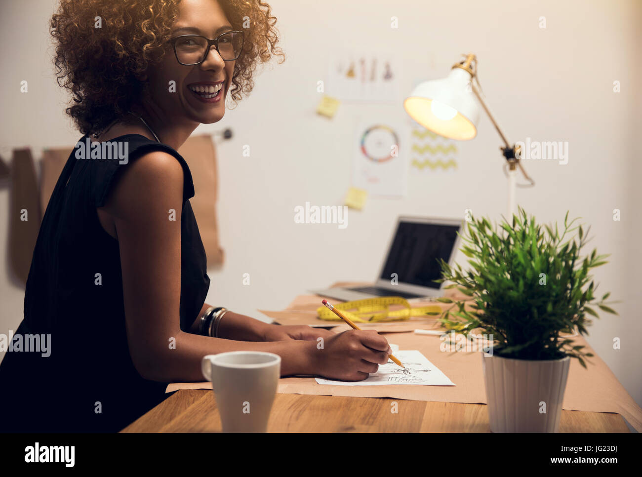 A young fashion designer working on her atelier Stock Photo - Alamy