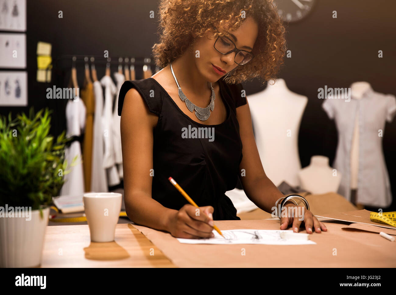 A young fashion designer working on her atelier Stock Photo - Alamy