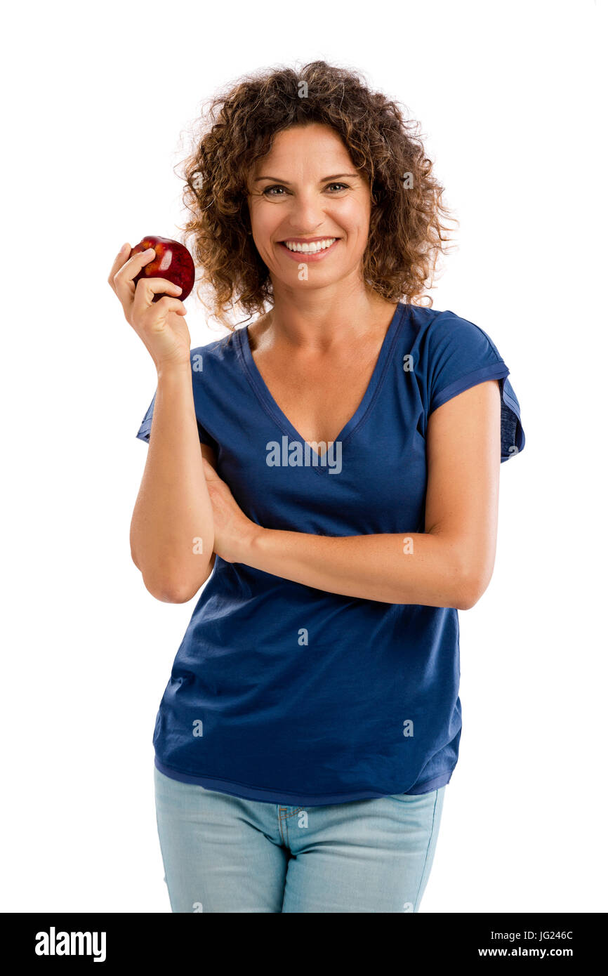 Portrait of a middle aged woman holding an apple and smiling Stock Photo
