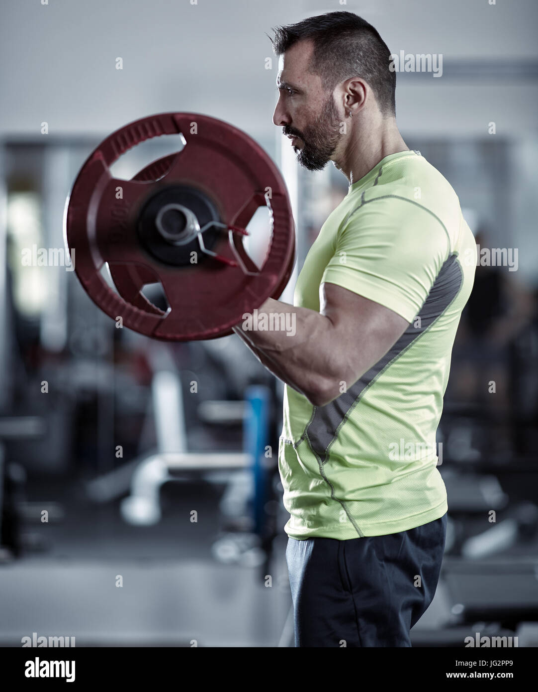 Man doing biceps curl with barbell in the gym Stock Photo - Alamy