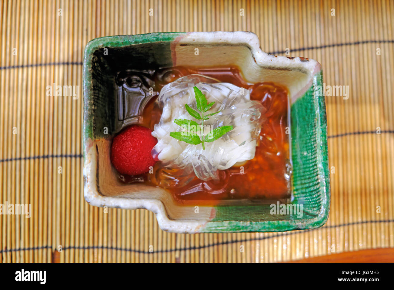 Soft tofu served with shirataki noodles, Japanese plum and soy sauce at Hirobun restaurant in Kibune. Stock Photo