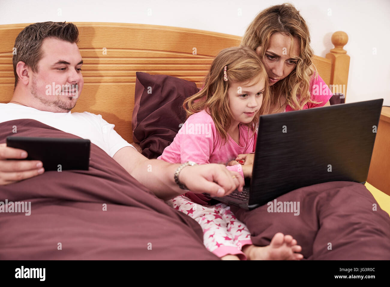 Family using electronical devices Stock Photo