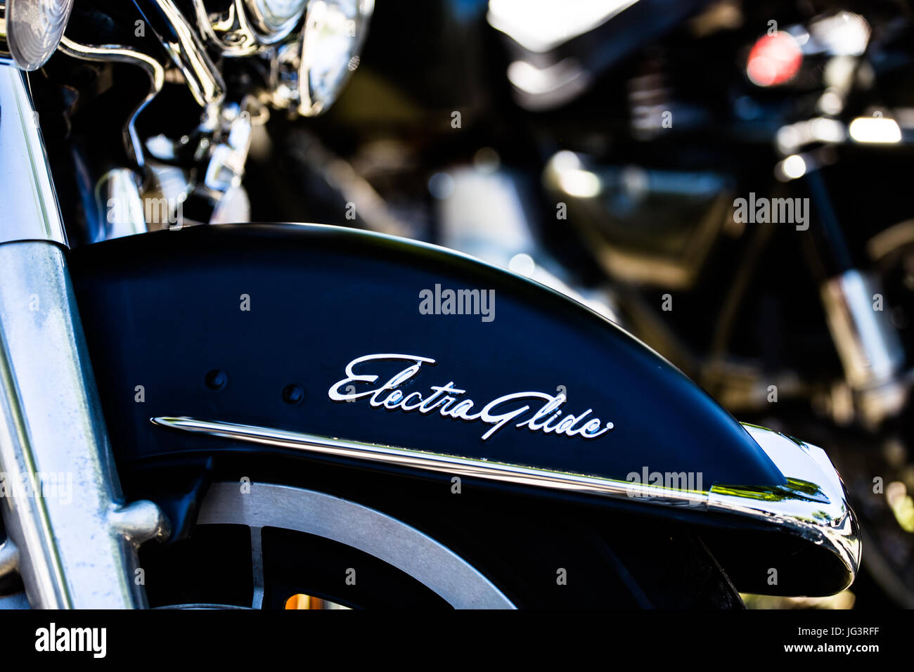 'Electra Glide' name on a black fender of a 'Harley Davidson Electra Glide' motorcycle. Stock Photo