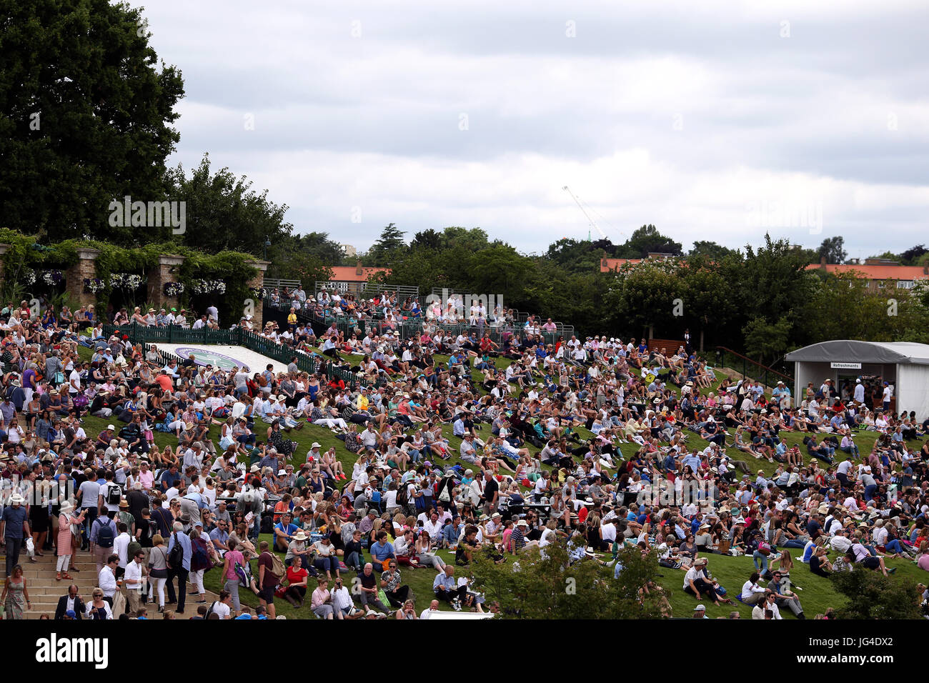 Spectators on Murray Mount on day one of the Wimbledon Championships at The All England Lawn Tennis and Croquet Club, Wimbledon. Stock Photo