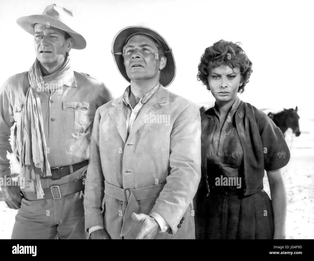 LEGEND OF THE LOST 1957 United Artists film with from left: John Wayne, Rossano Brazzi, Sophia Loren Stock Photo