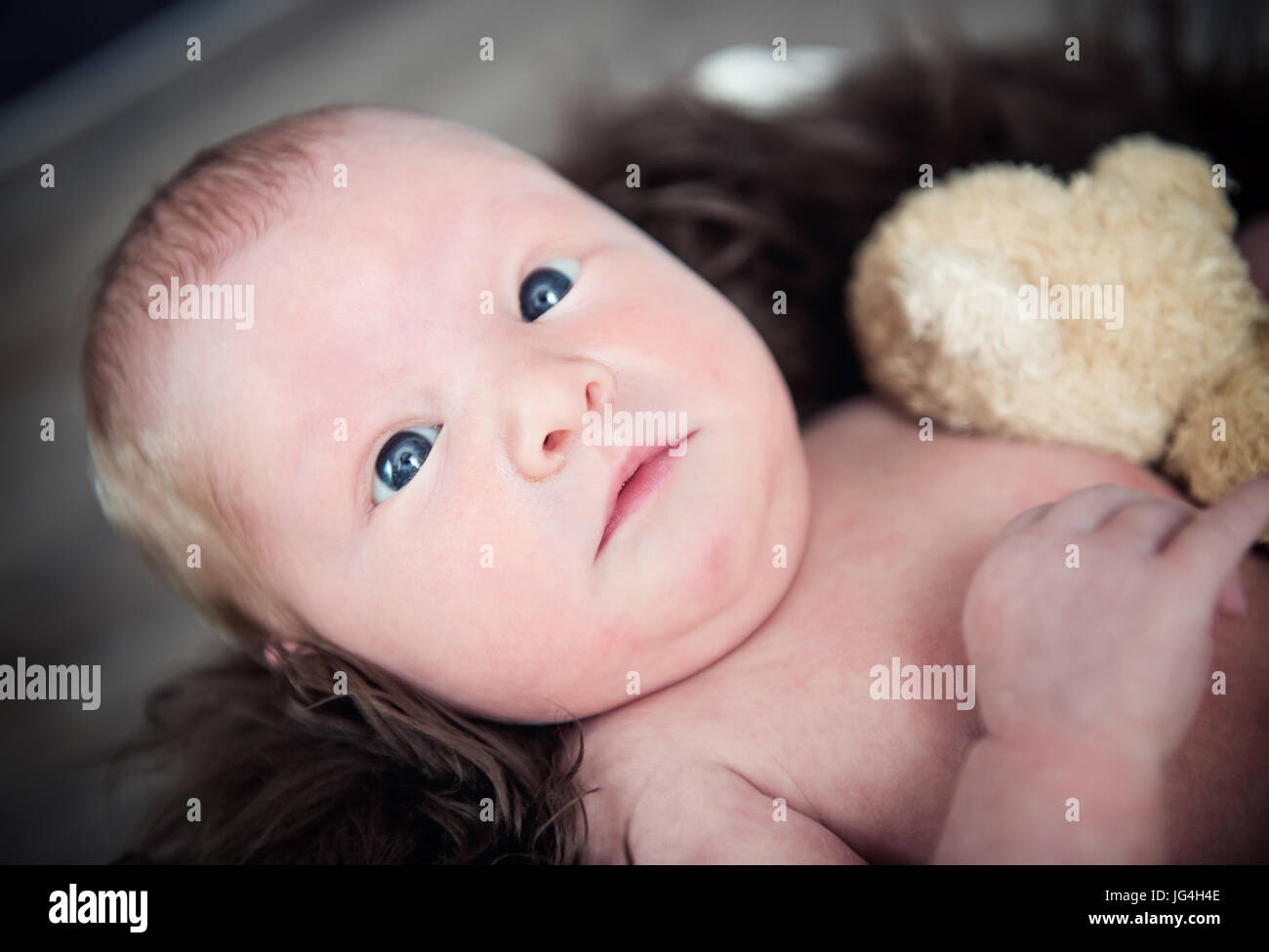 Newborn baby smiling looking at the camera Stock Photo