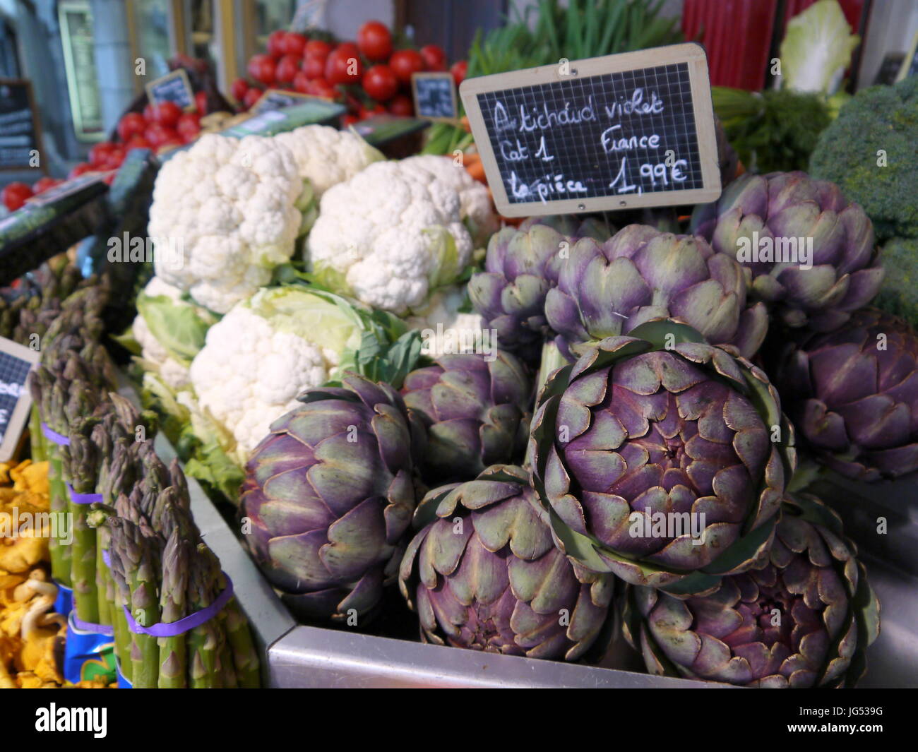 Fresh purple artichoke flowers on display in a grocery shop in